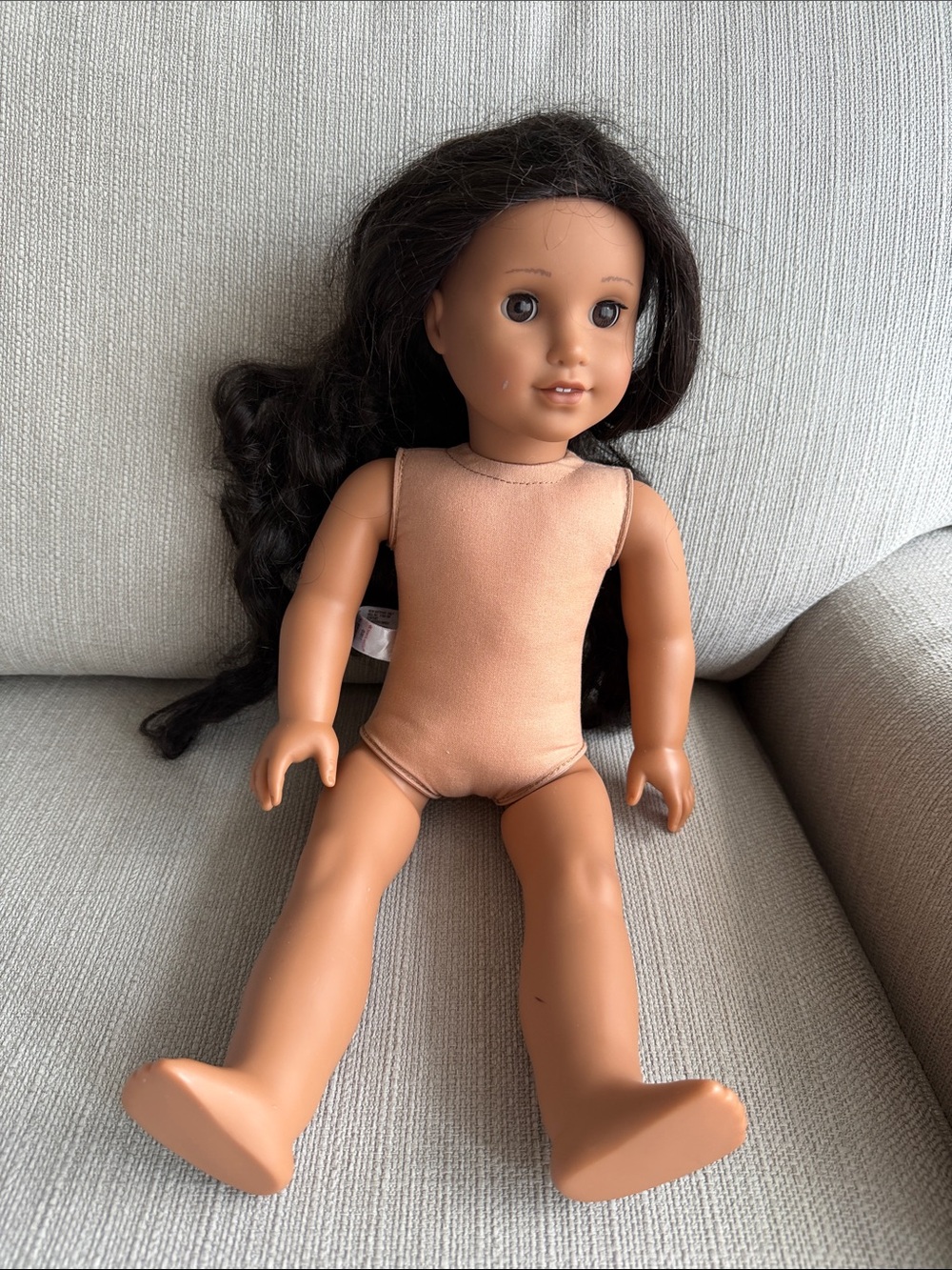 American girl doll with tan skin and dark hair